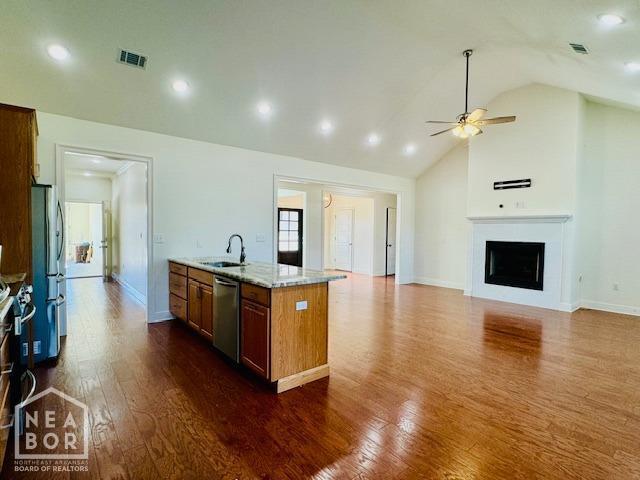 3803 Stone Ridge Dr, Paragould, AR 72450 - kitchen with a sink, appliances with stainless steel finishes, a ceiling fan, dark wood finished floors, and light stone countertops