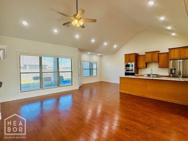 3803 Stone Ridge Dr, Paragould, AR 72450 - kitchen featuring stainless steel appliances, light countertops, brown cabinetry, a sink, and ceiling fan