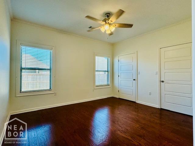 3803 Stone Ridge Dr, Paragould, AR 72450 - spare room with ornamental molding, dark wood finished floors, a ceiling fan, and baseboards