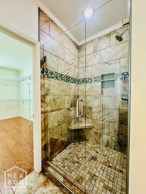 3803 Stone Ridge Dr, Paragould, AR 72450 - full bathroom with crown molding, a stall shower, and a spacious closet