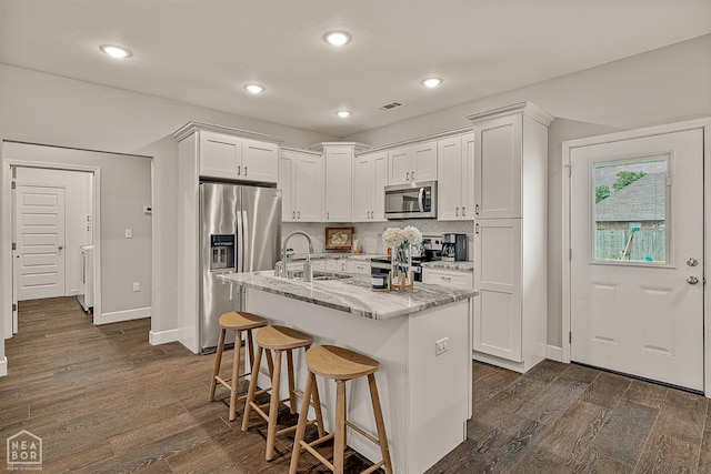 3604 Fieldstone Dr, Paragould, AR 72450 - kitchen featuring stainless steel appliances, white cabinetry, dark wood-style flooring, and recessed lighting