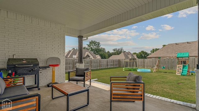 3604 Fieldstone Dr, Paragould, AR 72450 - fenced backyard with a playground, a patio area, grilling area, an outdoor living space, and a trampoline