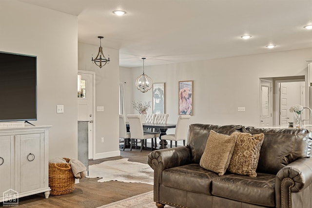 3604 Fieldstone Dr, Paragould, AR 72450 - living room featuring wood finished floors, a chandelier, and recessed lighting