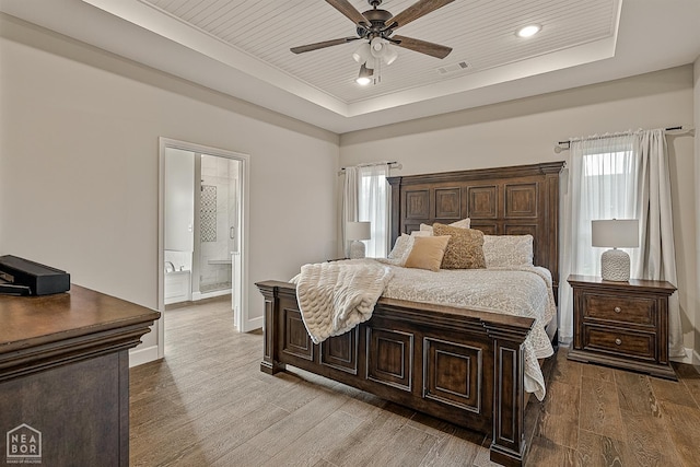 3604 Fieldstone Dr, Paragould, AR 72450 - bedroom featuring a tray ceiling, wood finished floors, multiple windows, ensuite bathroom, and wooden ceiling