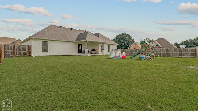 3604 Fieldstone Dr, Paragould, AR 72450 - rear view of property featuring a playground, a fenced backyard, a patio, and roof with shingles