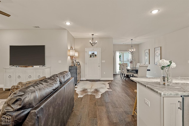 3604 Fieldstone Dr, Paragould, AR 72450 - living room with a chandelier, dark wood-style flooring, recessed lighting, and wine cooler