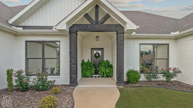 3604 Fieldstone Dr, Paragould, AR 72450 - doorway to property with brick siding, board and batten siding, and roof with shingles