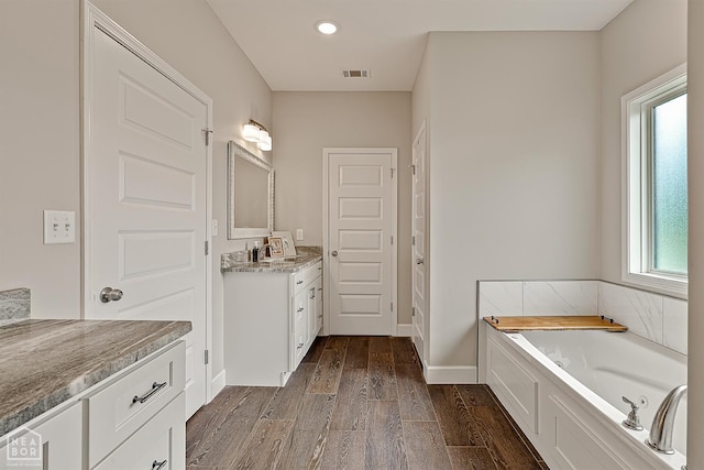 3604 Fieldstone Dr, Paragould, AR 72450 - bathroom with vanity, wood finished floors, a garden tub, and recessed lighting