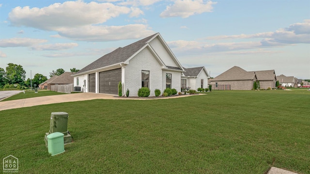 3604 Fieldstone Dr, Paragould, AR 72450 - view of front of house with concrete driveway, an attached garage, a front lawn, and brick siding
