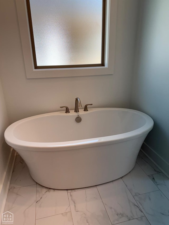 3101 Bear Creek Cv, Jonesboro, AR 72404 - full bathroom with marble look tiles and a freestanding tub