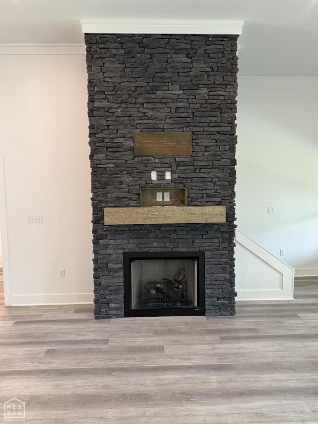 3101 Bear Creek Cv, Jonesboro, AR 72404 - detailed view of a stone fireplace, ornamental molding, and wood finished floors