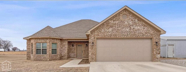 807 Byron Ln, Manila, AR 72442 - view of front of home featuring brick siding, driveway, an attached garage, and a shingled roof