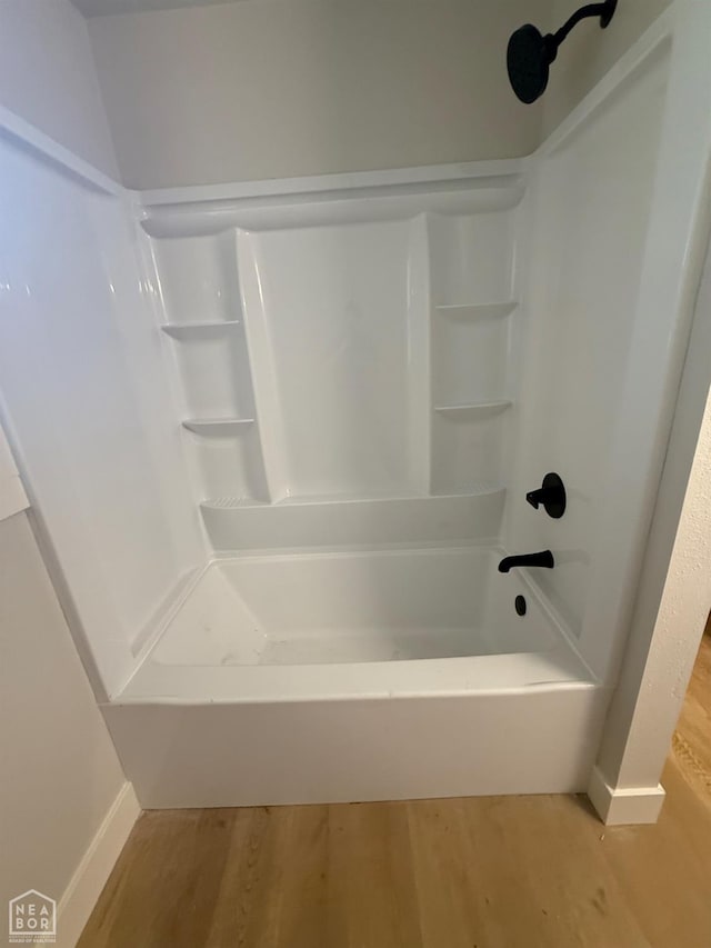 2408 Harper St, Corning, AR 72422 - bathroom featuring wood finished floors and shower / washtub combination