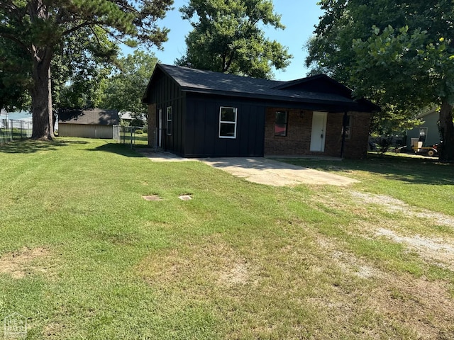 2408 Harper St, Corning, AR 72422 - view of front facade with board and batten siding and a patio area
