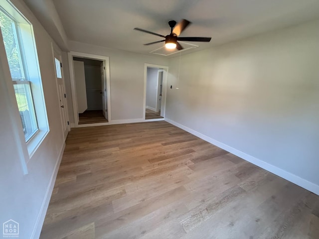 2408 Harper St, Corning, AR 72422 - unfurnished bedroom featuring light wood finished floors, a spacious closet, a closet, and a ceiling fan