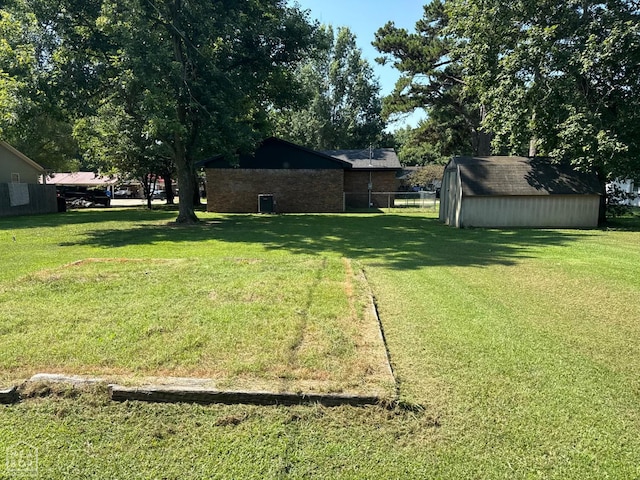 2408 Harper St, Corning, AR 72422 - view of grassy yard with a storage unit