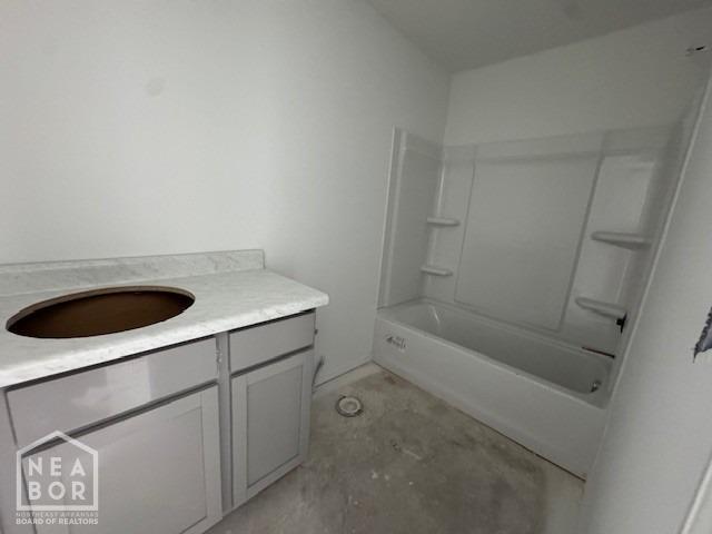 5706 Boone St, Jonesboro, AR 72404 - bathroom featuring unfinished concrete flooring, vanity, and bathtub / shower combination