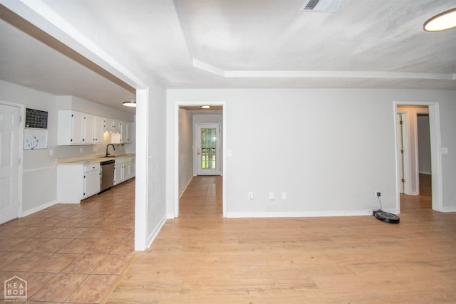2209 Greensboro Rd, Jonesboro, AR 72405 - unfurnished living room with a sink, light wood-style flooring, and baseboards