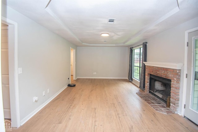 2209 Greensboro Rd, Jonesboro, AR 72405 - unfurnished living room with light wood finished floors, a fireplace, and baseboards