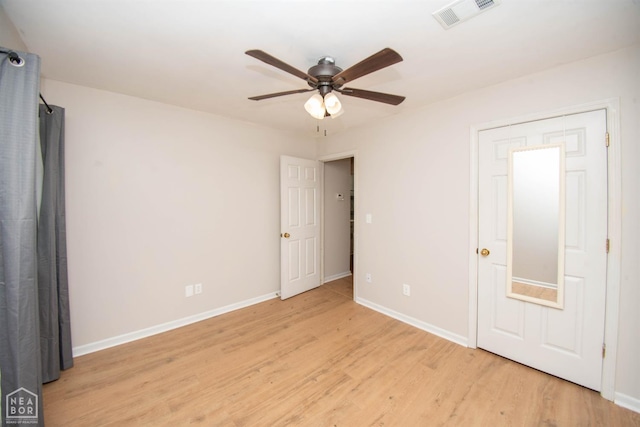 2209 Greensboro Rd, Jonesboro, AR 72405 - unfurnished bedroom with light wood finished floors, baseboards, and a ceiling fan