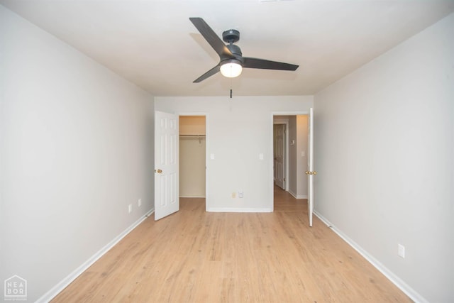 2209 Greensboro Rd, Jonesboro, AR 72405 - unfurnished bedroom with light wood-style flooring, baseboards, a spacious closet, a closet, and ceiling fan