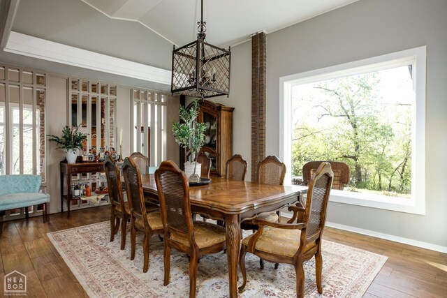 404 E Griffin St, Harrisburg, AR 72432 - dining area featuring hardwood / wood-style floors, a wealth of natural light, and a chandelier