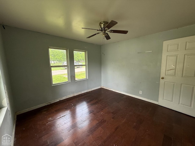 414 E 1st St, Rector, AR 72461 - empty room featuring a ceiling fan, dark wood-style floors, and baseboards