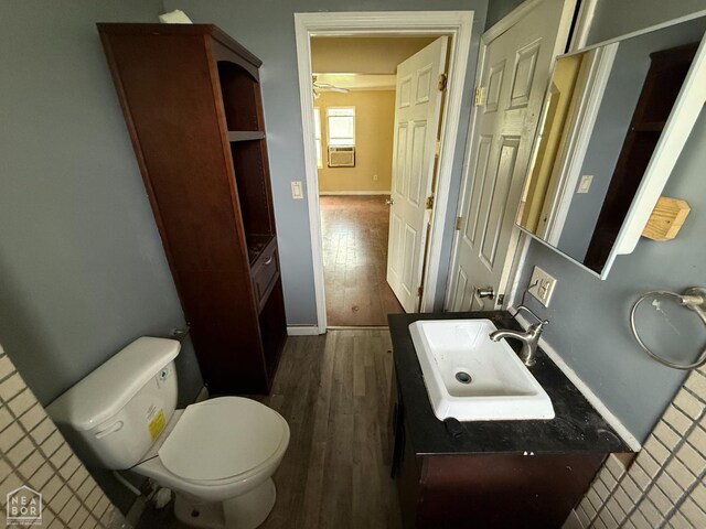 414 E 1st St, Rector, AR 72461 - half bath with wood finished floors, toilet, baseboards, vanity, and a ceiling fan