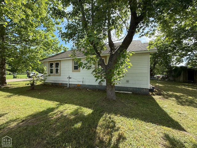 414 E 1st St, Rector, AR 72461 - view of side of home with a lawn and roof with shingles