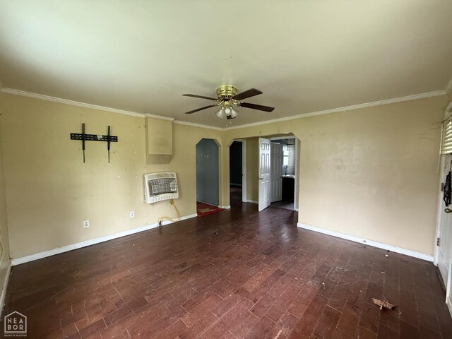 414 E 1st St, Rector, AR 72461 - unfurnished living room featuring heating unit, a ceiling fan, ornamental molding, wood finished floors, and baseboards