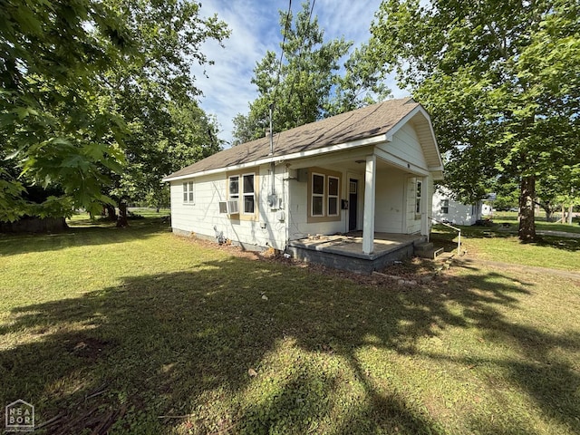 414 E 1st St, Rector, AR 72461 - rear view of house featuring a yard, a shingled roof, and cooling unit