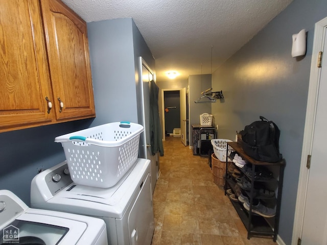 800 Hilltop Dr, Piggott, AR 72454 - washroom with cabinet space, separate washer and dryer, and a textured ceiling