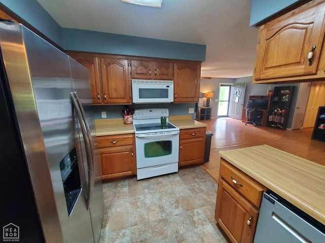 800 Hilltop Dr, Piggott, AR 72454 - kitchen with appliances with stainless steel finishes, light countertops, and brown cabinets