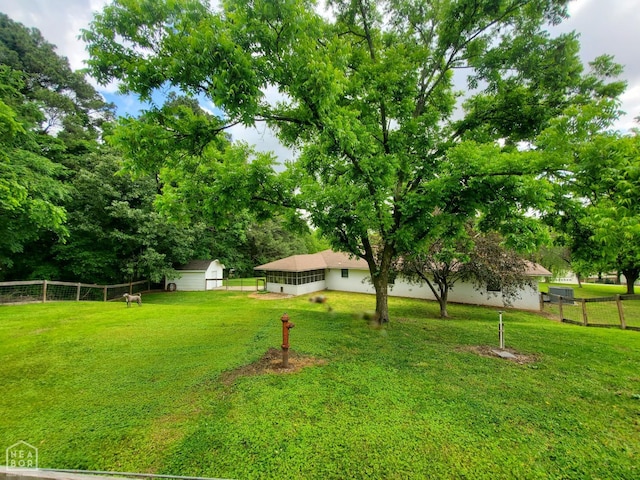 800 Hilltop Dr, Piggott, AR 72454 - view of yard featuring a storage unit and an outbuilding