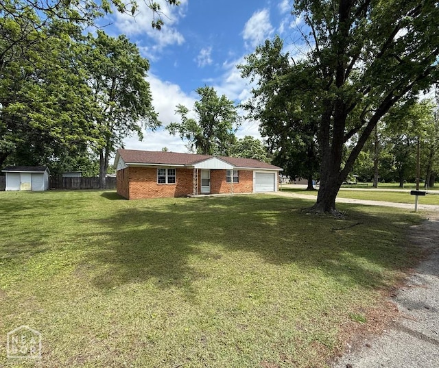ranch-style house with a storage shed, a garage, fence, a front lawn, and brick siding