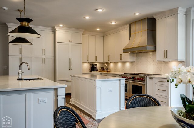 1203 Dove Rd, Jonesboro, AR 72401 - kitchen featuring custom exhaust hood, range with two ovens, a kitchen island, a sink, and light countertops