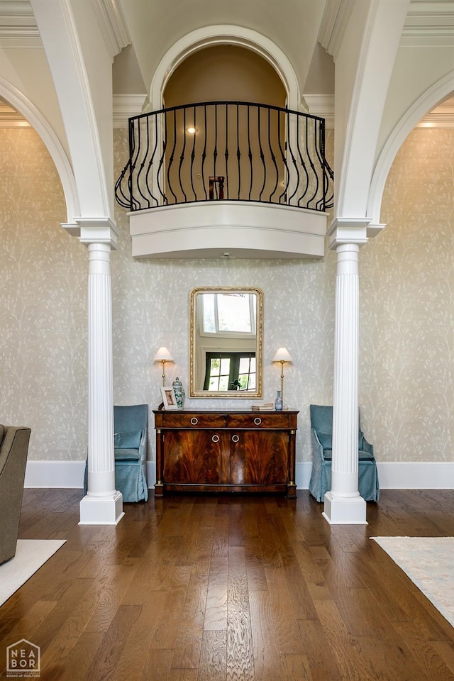 1203 Dove Rd, Jonesboro, AR 72401 - foyer entrance with decorative columns, hardwood / wood-style floors, wallpapered walls, arched walkways, and crown molding