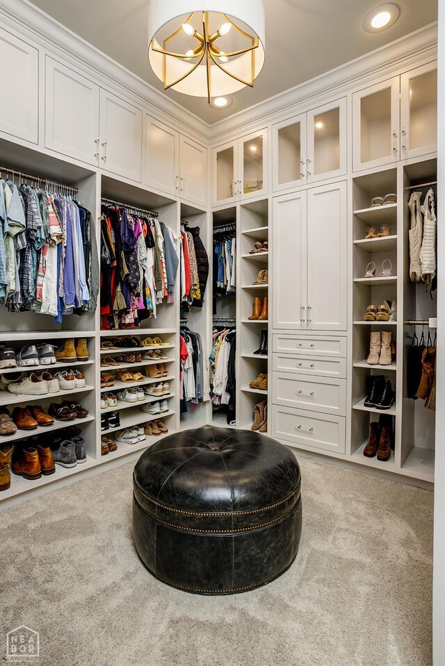 1203 Dove Rd, Jonesboro, AR 72401 - walk in closet featuring carpet floors and a chandelier