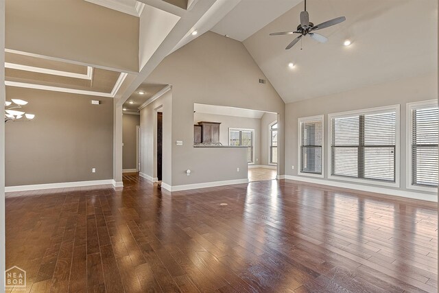 2216 Williamsburg Dr, Jonesboro, AR 72404 - unfurnished living room with baseboards, ornamental molding, high vaulted ceiling, ceiling fan with notable chandelier, and wood finished floors