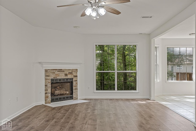4604 Stillwater, Jonesboro, AR 72404 - unfurnished living room featuring a ceiling fan, wood finished floors, a fireplace, and baseboards