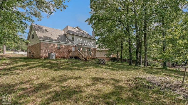 4604 Stillwater, Jonesboro, AR 72404 - back of house featuring brick siding, a deck, a lawn, and a chimney