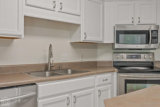 4604 Stillwater, Jonesboro, AR 72404 - kitchen with appliances with stainless steel finishes, a sink, and white cabinetry