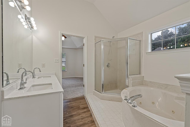 4604 Stillwater, Jonesboro, AR 72404 - full bathroom with a stall shower, lofted ceiling, a tub with jets, double vanity, and wood finished floors