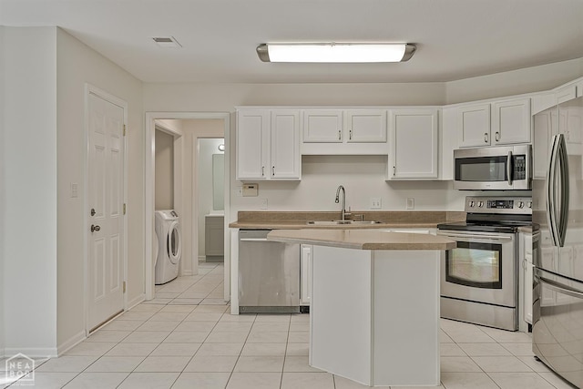 4604 Stillwater, Jonesboro, AR 72404 - kitchen with stainless steel appliances, a sink, light tile patterned floors, and white cabinetry