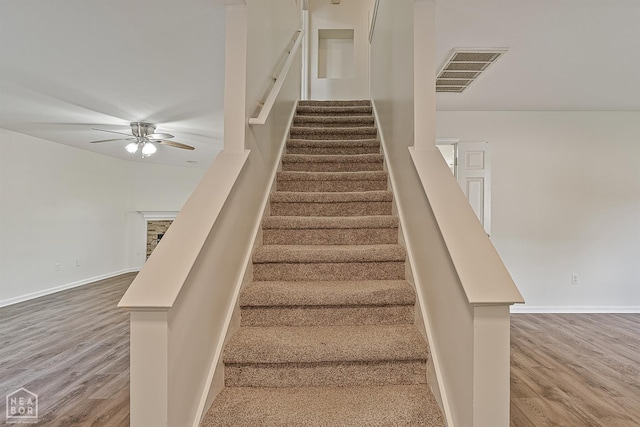 4604 Stillwater, Jonesboro, AR 72404 - staircase with wood finished floors, ceiling fan, and baseboards