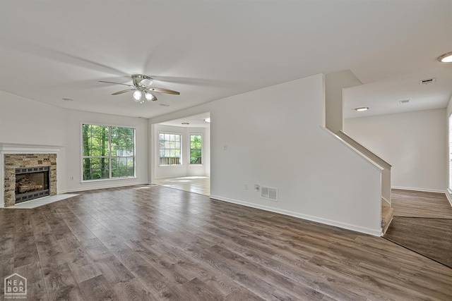 4604 Stillwater, Jonesboro, AR 72404 - unfurnished living room with a ceiling fan, wood finished floors, baseboards, and a fireplace