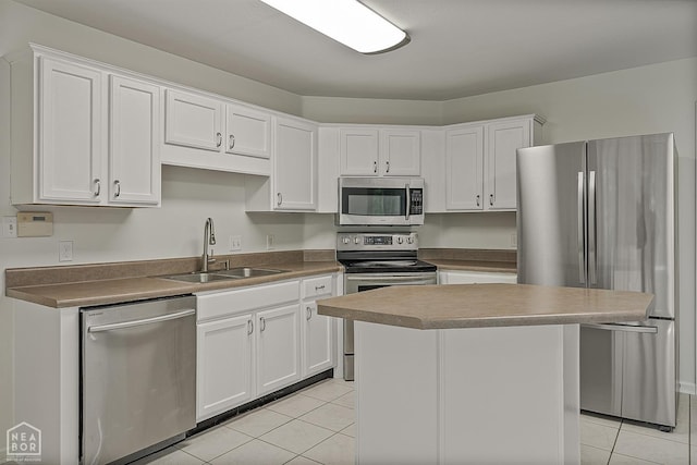 4604 Stillwater, Jonesboro, AR 72404 - kitchen featuring appliances with stainless steel finishes, a sink, light tile patterned flooring, and white cabinetry