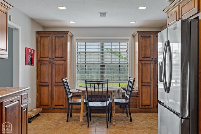 5007 S 28th St, Paragould, AR 72450 - kitchen featuring stainless steel fridge with ice dispenser, recessed lighting, light tile patterned floors, and a textured ceiling