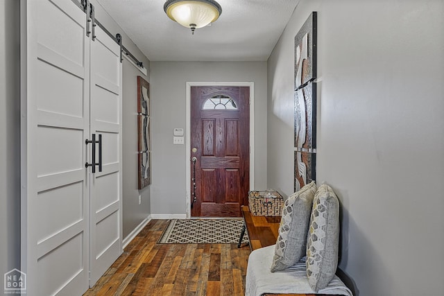 5007 S 28th St, Paragould, AR 72450 - foyer entrance with a barn door, dark wood-style floors, and baseboards