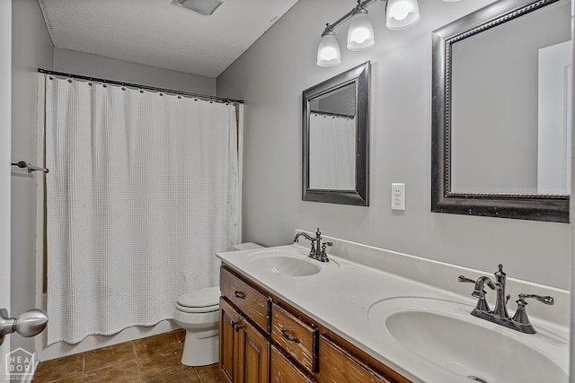 5007 S 28th St, Paragould, AR 72450 - bathroom featuring toilet, double vanity, shower / tub combo with curtain, tile patterned floors, and a textured ceiling